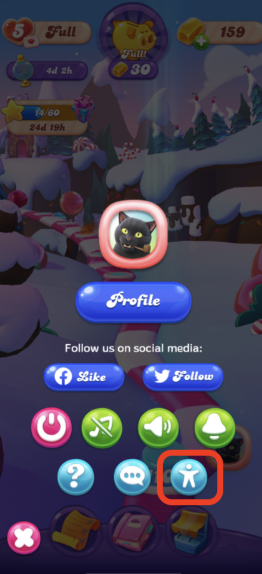 Οθόνη εντός παιχνιδιού στο «Candy Crush Friends Saga» με το κουμπί «Profile» και διάφορα εικονίδια, συμπεριλαμβανομένου τονισμένου εικονιδίου «Accessibility» μέσα σε κόκκινο τετράγωνο στο κάτω μέρος.
